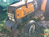 a small tractor that is parked in the grass