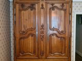 a large wooden armoire in the corner of a room