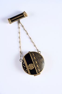 a close up of a black and gold necklace with a chain