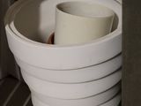 a white toilet bowl with a roll of toilet paper in it