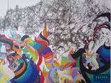 a painting on the wall of a building with a lot of people