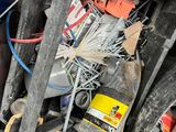 a pile of assorted items and tools in a garage