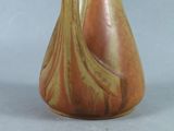 a vase that is sitting on a table with a gray background