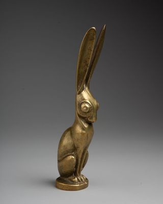a bronze statue of a rabbit sitting on its hind legs