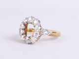 a close up of a diamond ring on a white surface