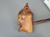 a wooden stick with a face on it next to a toothbrush