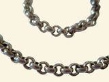 a silver necklace and bracelet on a white background