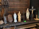 many statues of jesus and other religious figures on a shelf