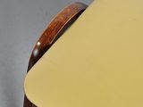 a close up of a chair with a yellow seat