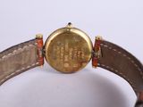 an image of a close up of a wrist watch on a white surface