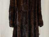 an image of a woman ' s fur coat on a mannequin stand