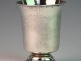 a silver cup that is sitting on a table