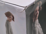 a box with a picture of a woman in a coat on it
