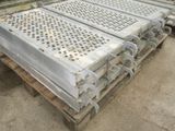 several pieces of metal are stacked on a pallet in a warehouse