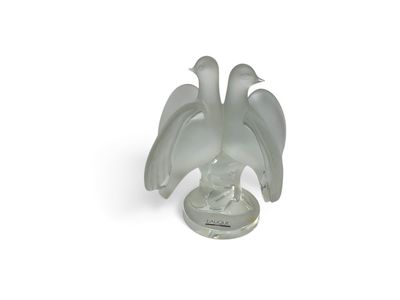 a glass figurine of a bird on a base