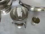 a silver plate and a silver cup on a table