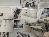 several old black and white photos of people and children on a table