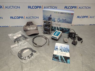 the contents of a camera, hat, and other items are on a table
