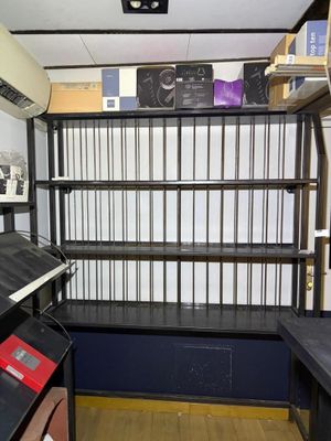 a room that has a shelf with many books on it
