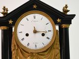 a black and gold clock with gold stars on it