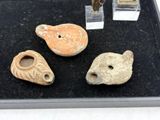 several pieces of pottery are displayed on a black tray