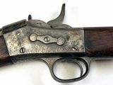 an old gun with a wooden handle on a white surface