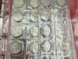 a lot of coins in a red binder