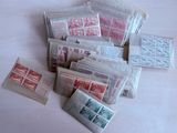 a pile of stamps on a table next to a pair of scissors