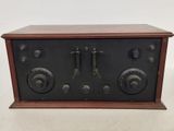 an old fashioned radio sitting on top of a wooden table