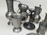 a lot of silver vases and cups on the table
