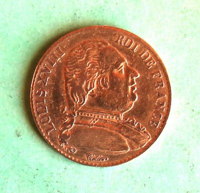a close up of a penny on a green surface
