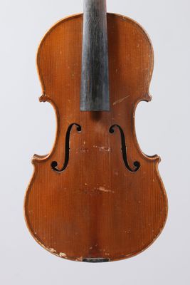 an old violin with a bow hanging from it ' s back
