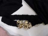 a belt that has a gold buckle on it