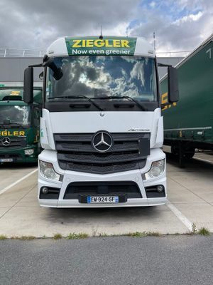 two trucks parked next to each other in a parking lot