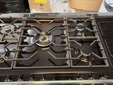 a gas stove that is sitting in the middle of a room