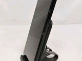 a cell phone that is on a stand on the table