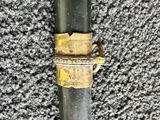 a metal pipe with a gold ring on it