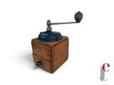 a small wooden box with a coffee grinder on top of it