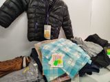a pile of clothes and a jacket on a table