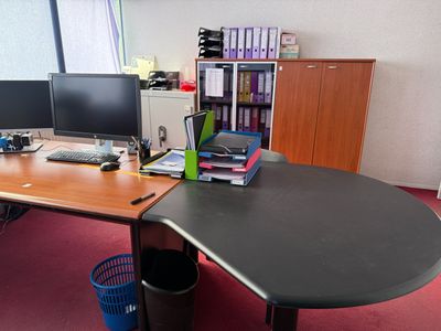 a desk with two monitors and a keyboard on it
