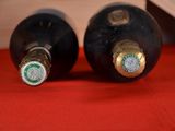 two bottles of wine that are sitting on a table