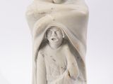a statue of a man and a woman holding a baby