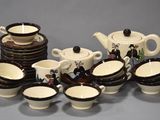 a lot of cups and saucers that are sitting on a table