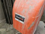 an orange piece of luggage that is sitting on the ground
