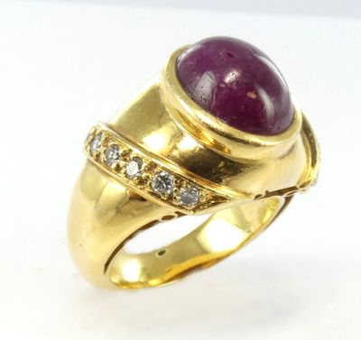 an image of a gold ring with a purple stone and diamonds