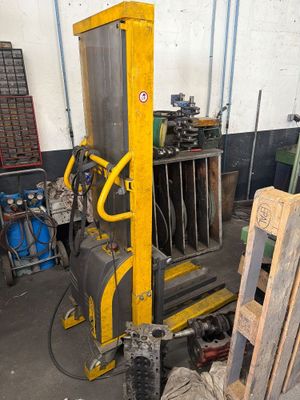 a fork lifter that is sitting in a garage