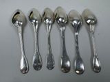 six spoons are lined up in a row on a table