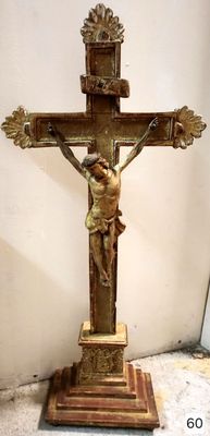 statue of jesus on the cross on a pedestal in a room