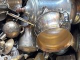 a box full of old silver pots and pans