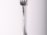 a silver fork and a silver spoon on a white surface